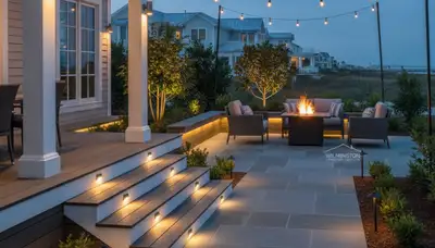 Illuminated patio and deck with post cap and step lights by Chop Chop Landscaping in Wilmington, NC