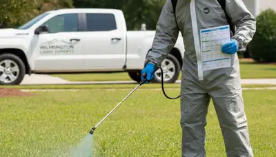 Technician applying targeted weed control on residential lawn in Wilmington, NC with professional sprayer